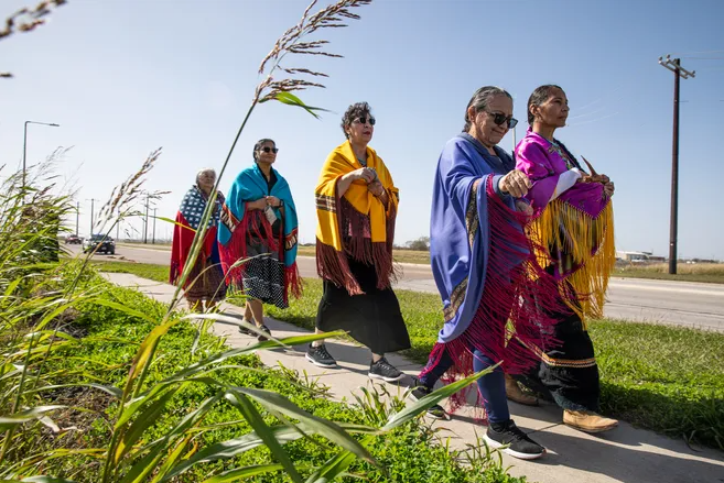 From front left, Donna Carrillo, of Kingsville, and Alfreda Mathieu, of Lafayette, La., spread tobacco to bless Ennis Joslin Road on Saturday, Jan. 13, 2024, in Corpus Christi, Texas. Carrillo walked in honor of her late husband Domingo Castro Carrillo, a Lipan Apache elder.
Angela Piazza/Caller-Times