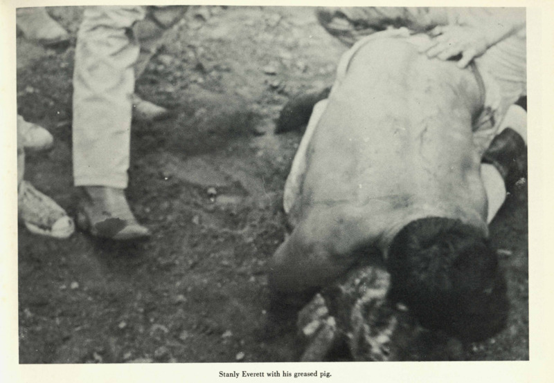 A man wrestling a greased pig. 