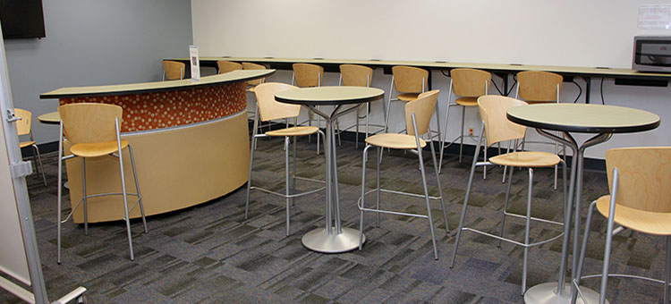 Inside Daily Read Cafe showing counter height tables and chairs including some normal height seating.