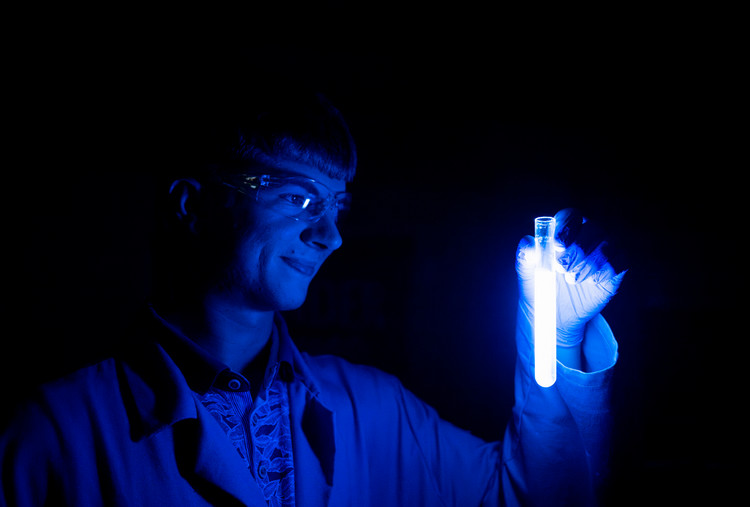 Chemistry+major+Connor+Duncan+holds+up+a+test+tube+containing+a+glowing+blue+chemical+substance+created+at+TAMU-CC.