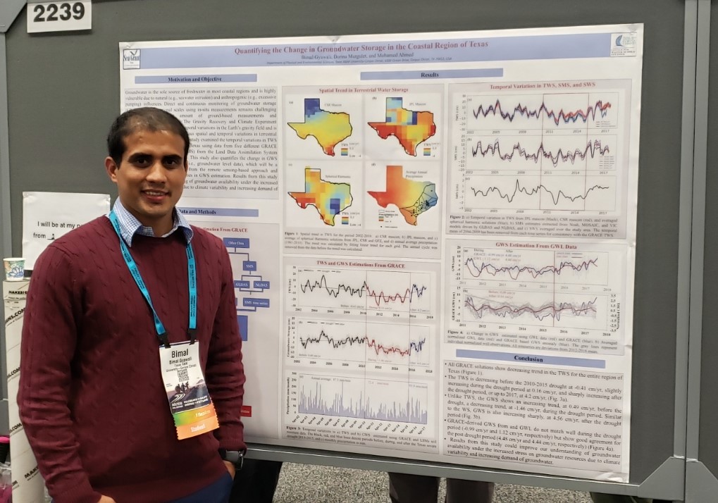 Bimal Gyawali staning next to his research poster